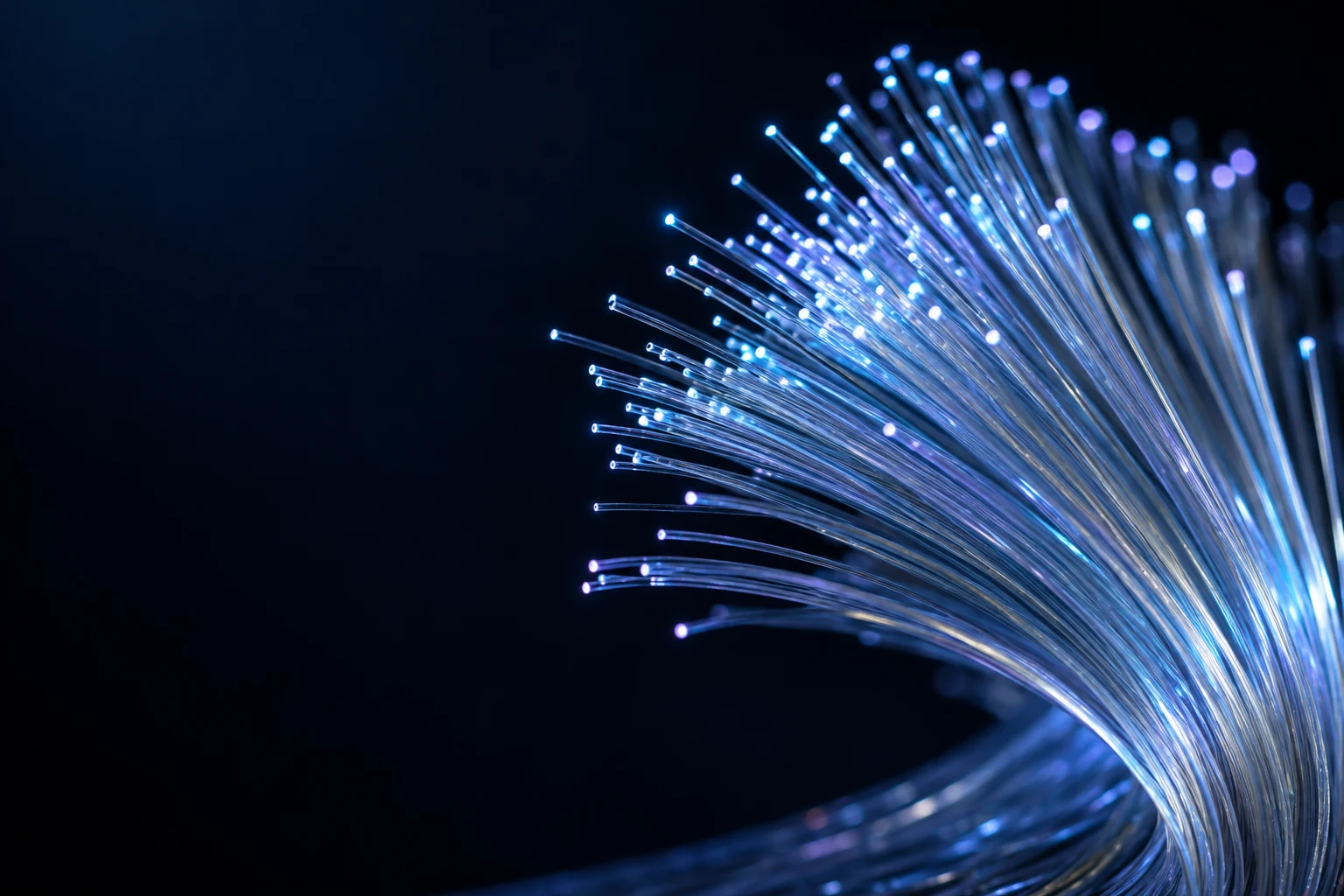 Fine optical glass fibers curving through cyan and violet light